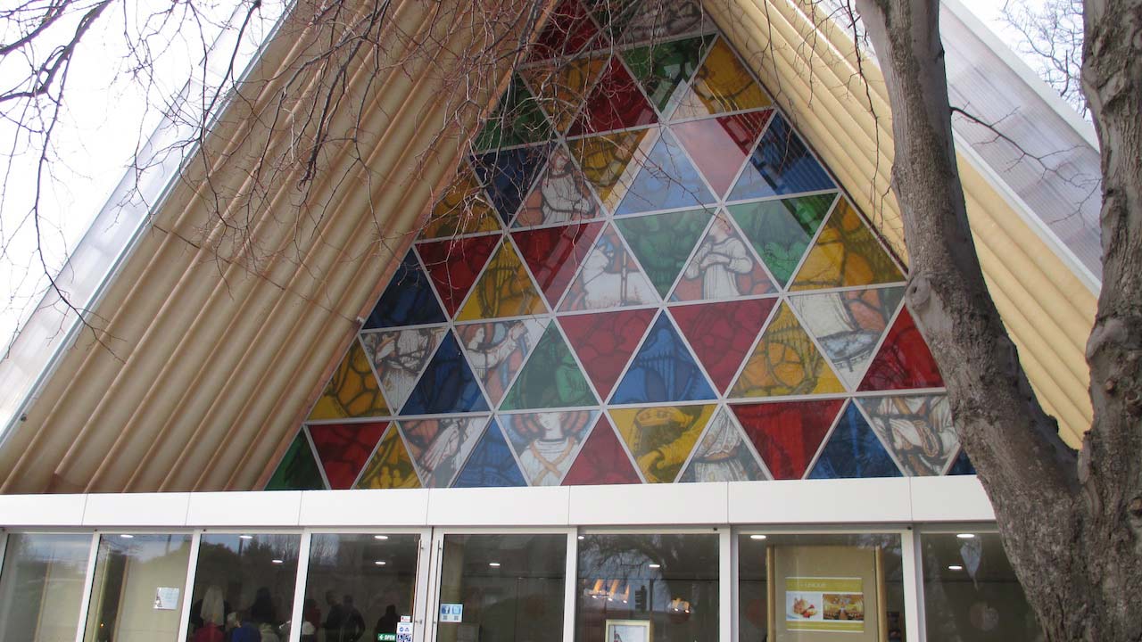 A triangular window filled with smaller colorful triangles