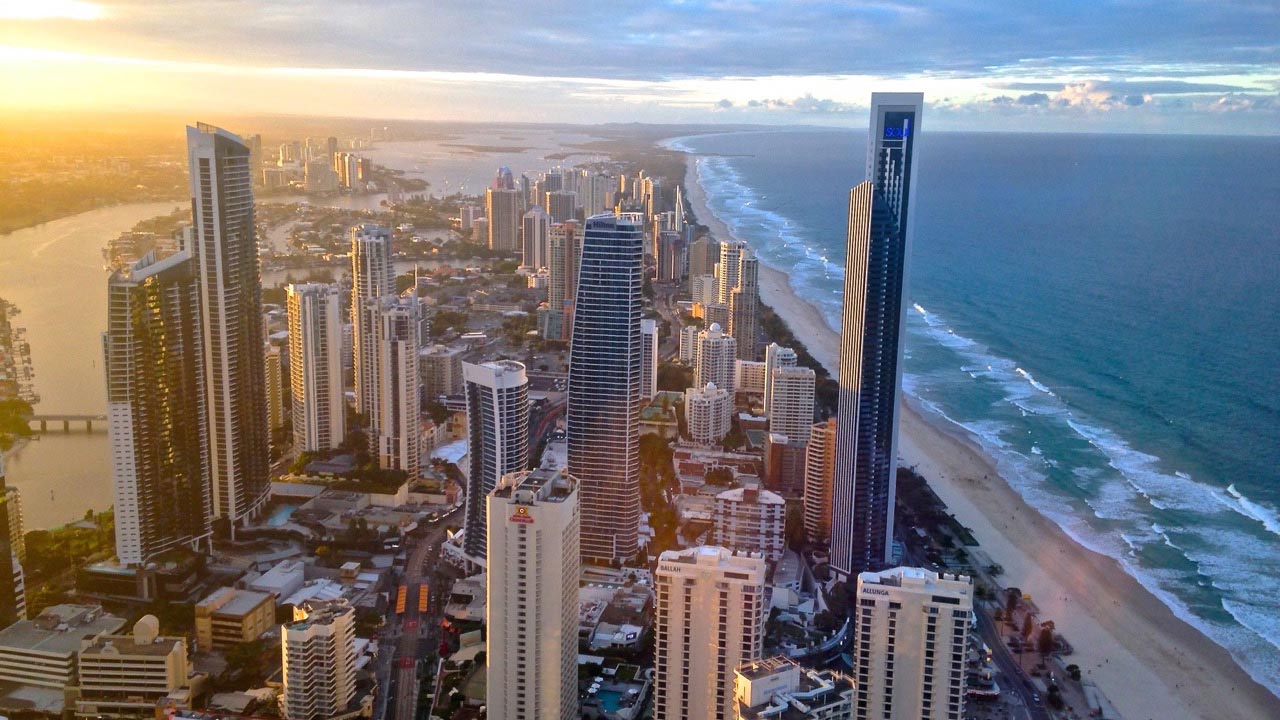 A bird's eye view of the Gold Coast's cityscape and coast as the sun sets