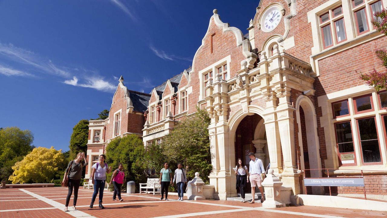 Students walk into a large, ornate building on Lincoln University campus