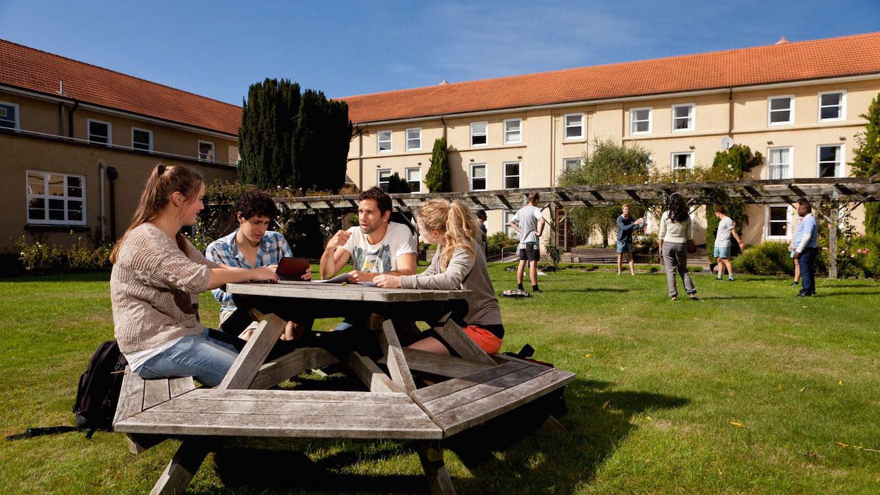 Students sit a picnic table on the quad on Lincoln University's campus