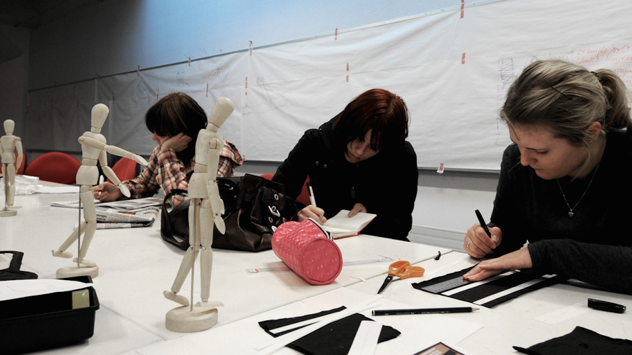 Students sit drawing still life of sculptures in class at Massey University Wellington's campus