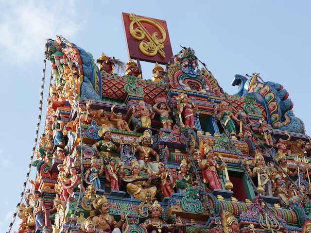 The top of an intricate Hindu temple in Singapore