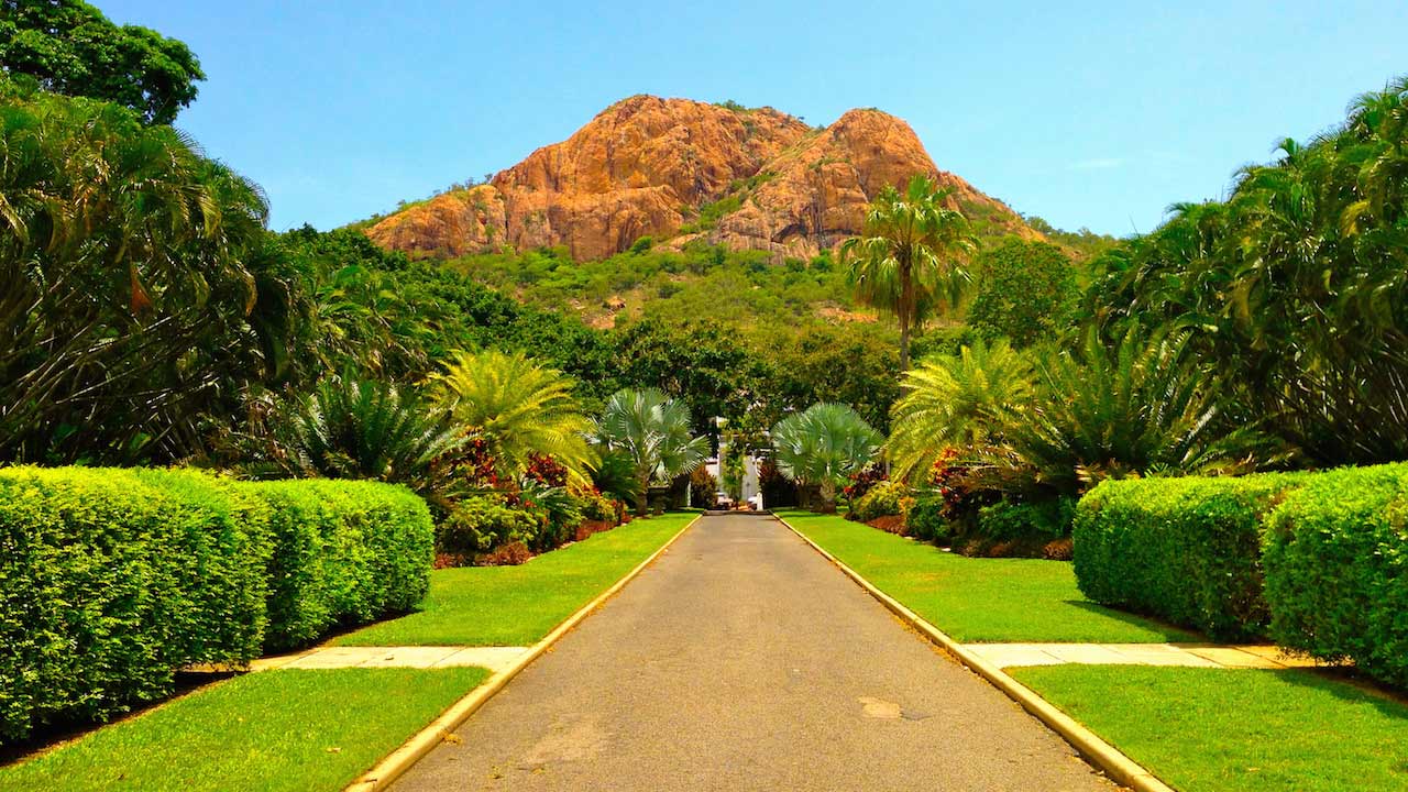 A pathway cuts through a lush, manicured garden in Townsville, Australia